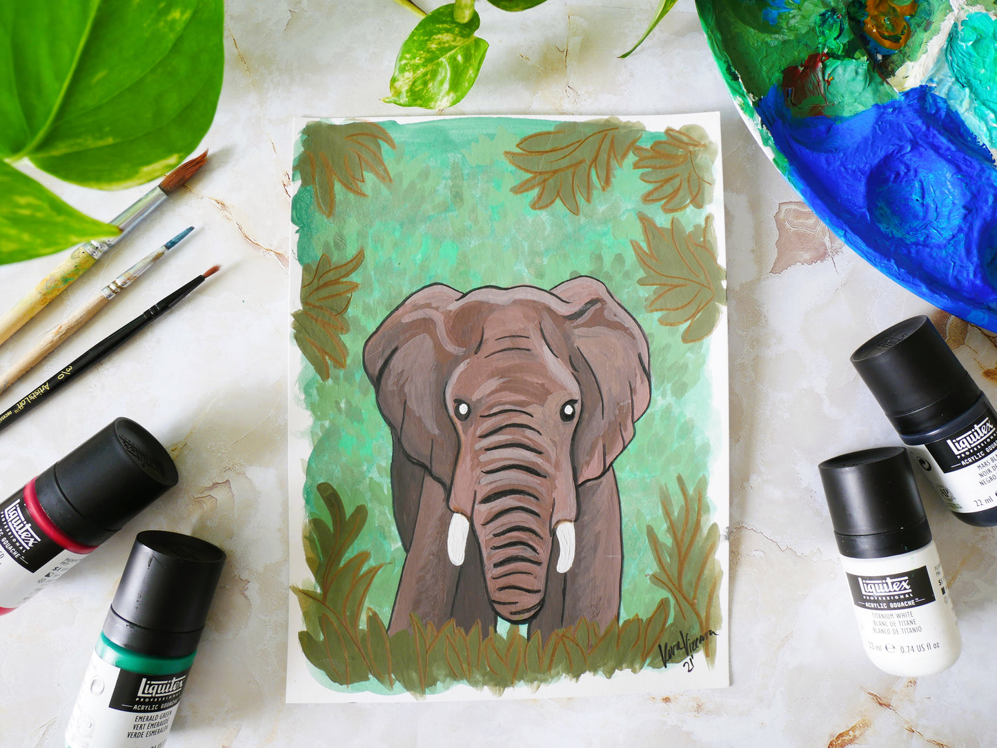 african elephant in forest gouache and pencil multimedia painting flatlay with paints and paint brushes to display size